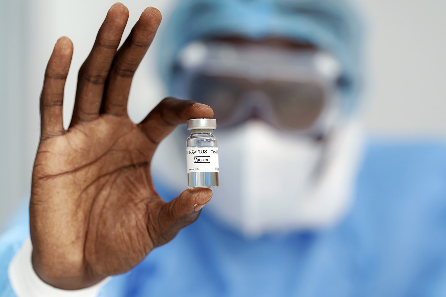 1800x1200_man_holding_coronavirus_vaccine.jpg
