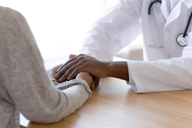 1800ss_getty_rf_doctor_patient_holding_hands.jpg