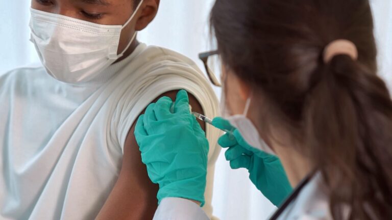 1800x1200_child_receiving_covid_vaccination_two_other.jpg